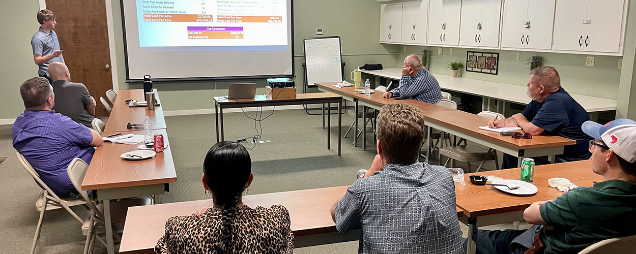 Lee Azevedo presenting on his summer internship experience to Olam staff