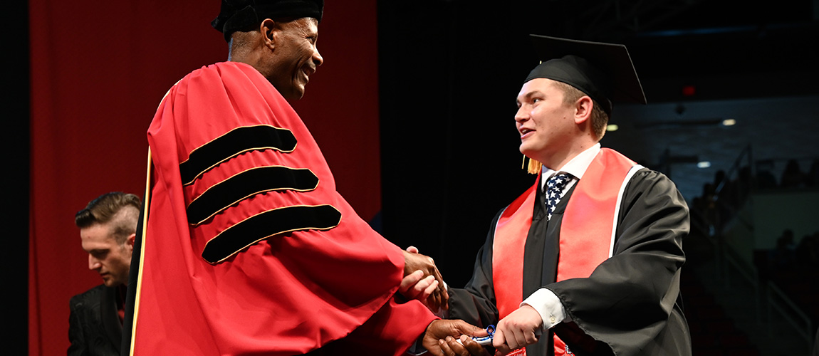 Reid Jacobs receives diploma at graduation from Dean St. Hilaire