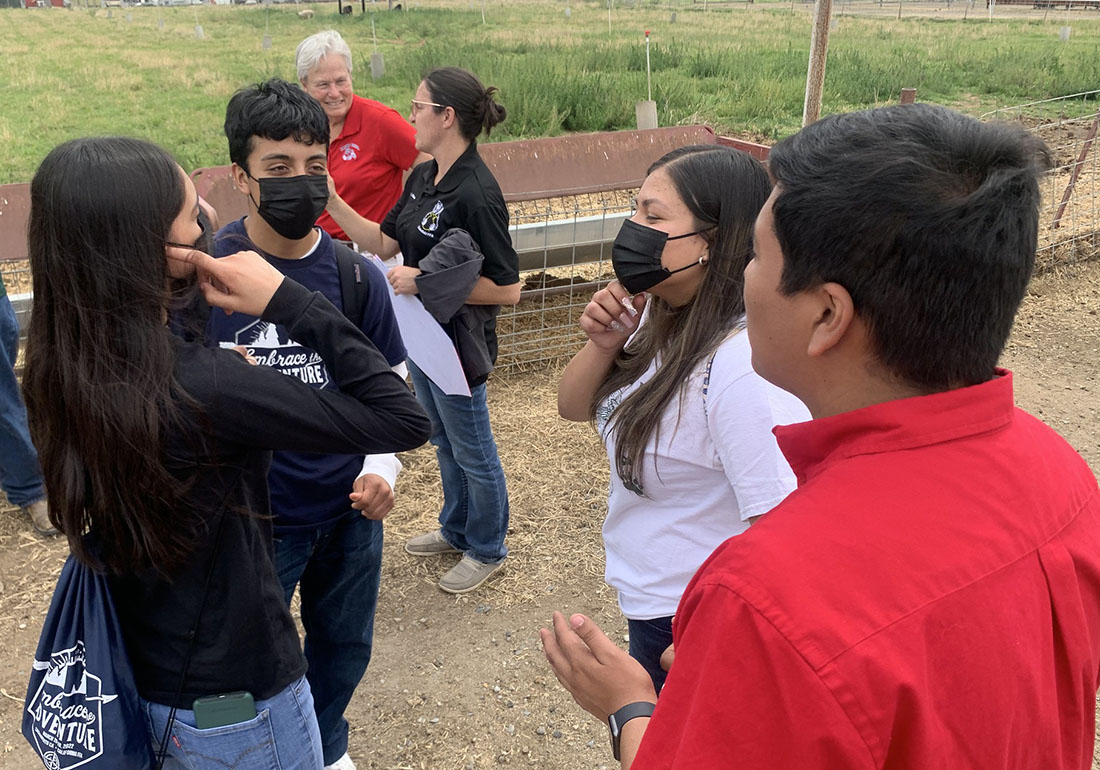 Fresno State student Ivan Trujillo and Dr. Sharon Freeman give a campus sheep unit tour for high school students through multicultural ambassadors outreach program.