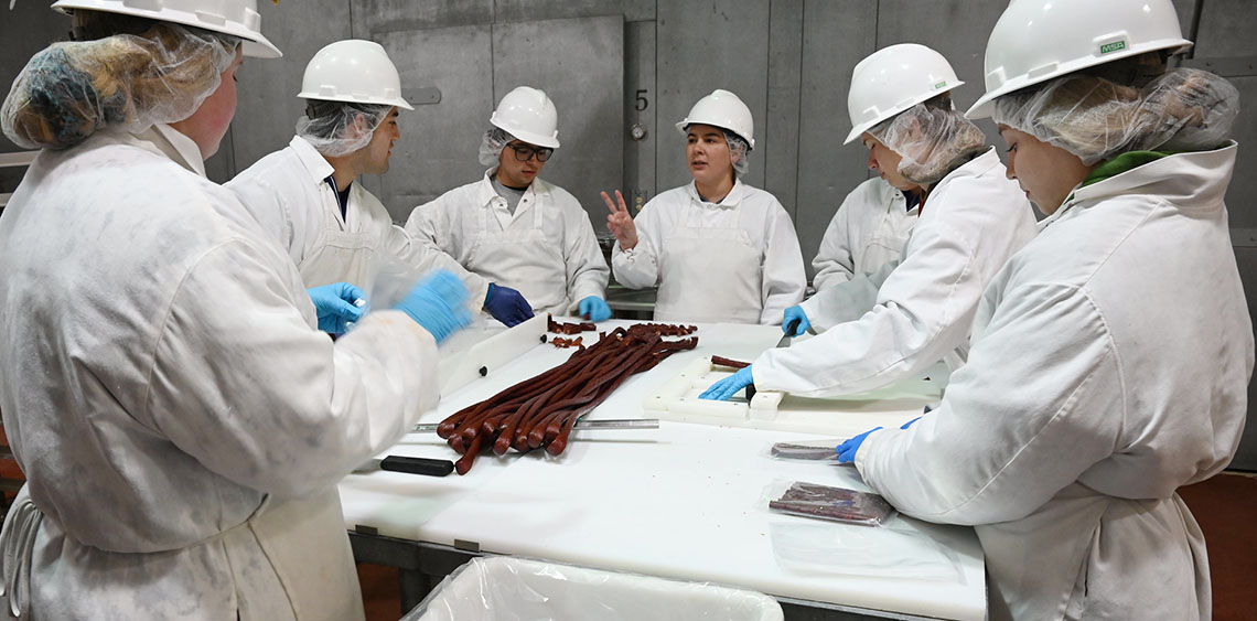 Montserrat Perez Valdez teaching students in meat science lab