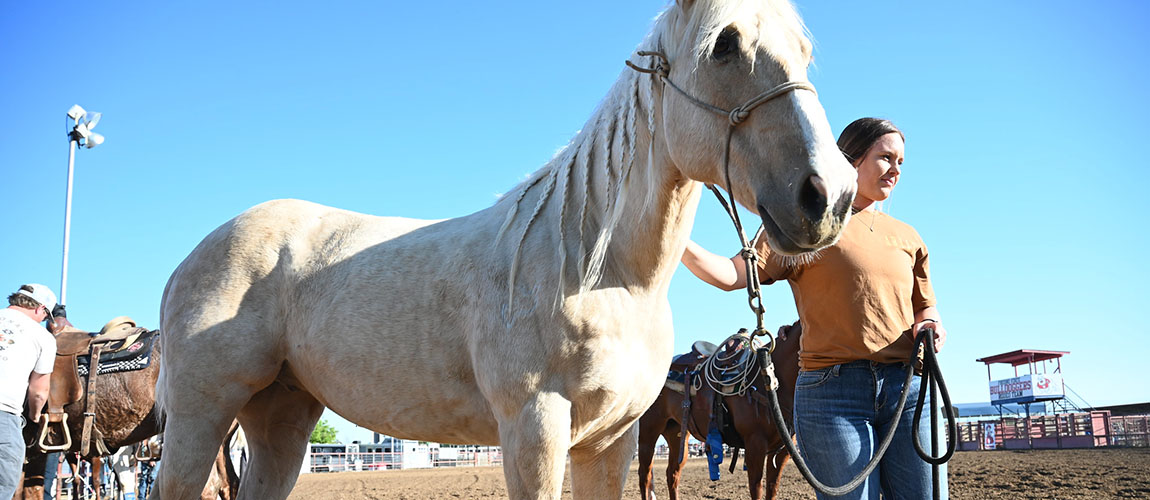 student riding horse 