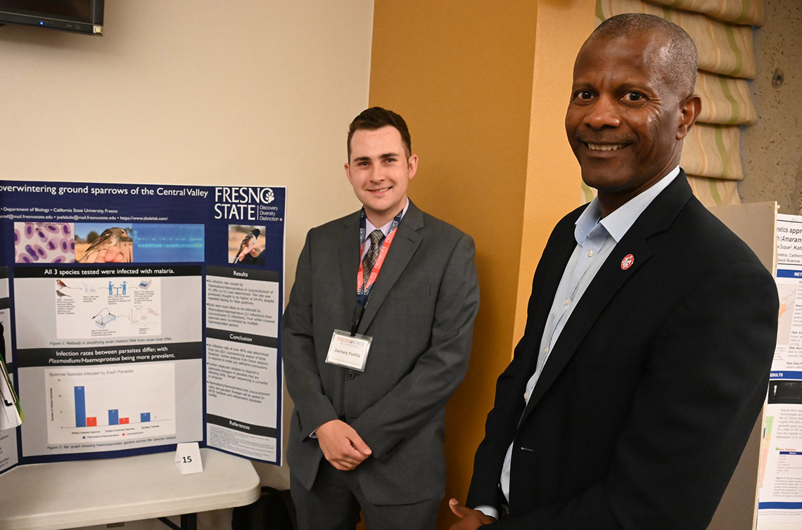 Zachardy Padilla presents his research to Jordan College Dean Rolston St. Hilaire.