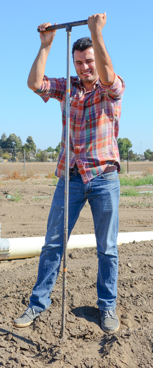 Student taking soil samples on Fresno State farm