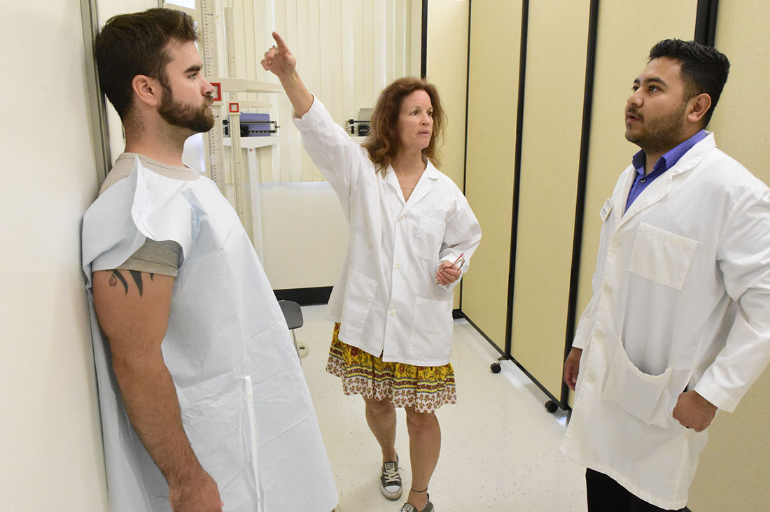 Lisa Herzig, Jonas Gomez, and Christopher Adams in the FSN lab