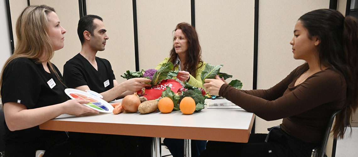 Dr. Lisa Herzig and students discuss nutrition plans.