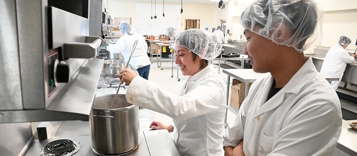 Culinology science class students cook in the FFS 108 lab.