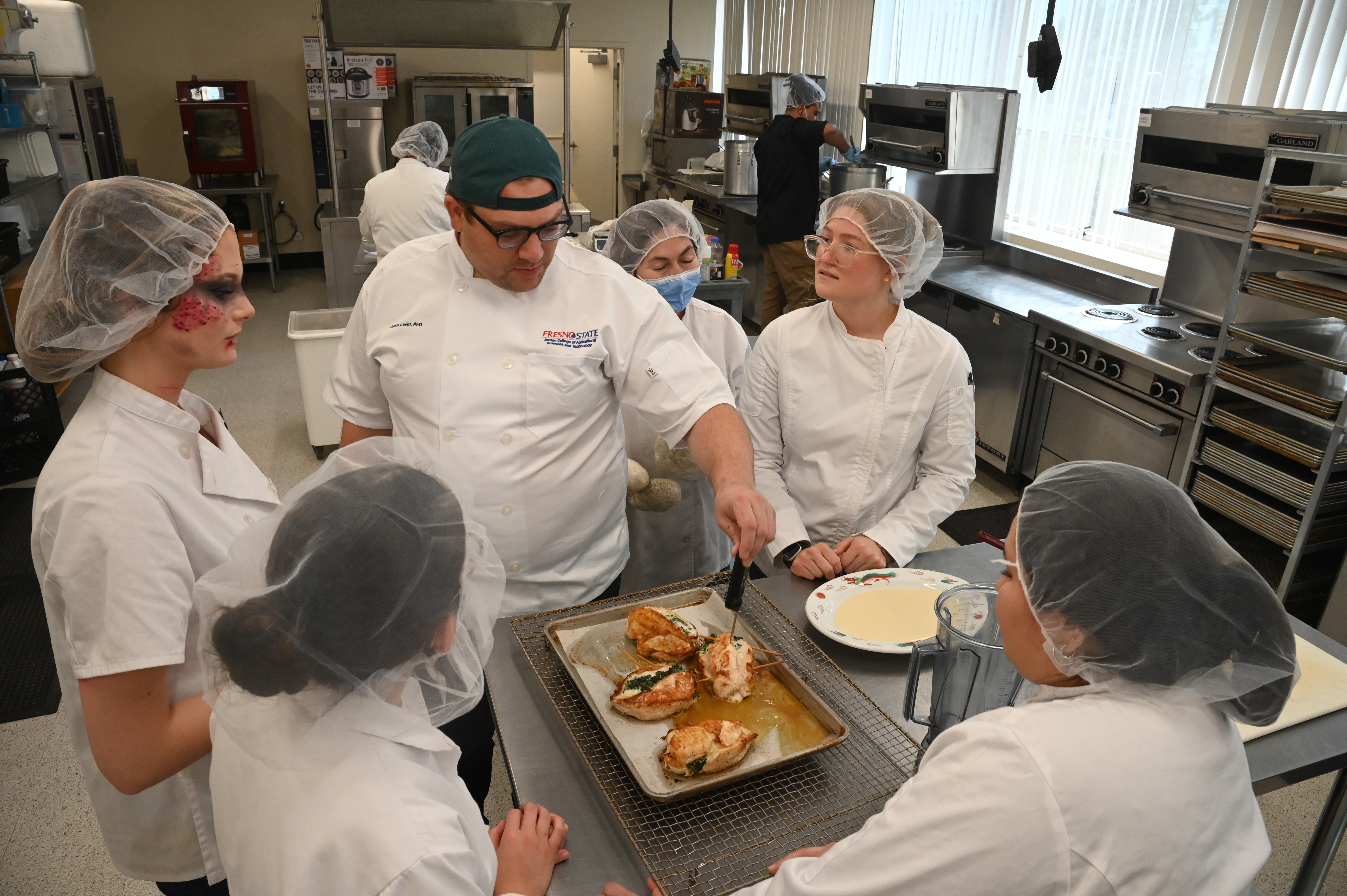 Dr. Sara Griffin and student baking pastries