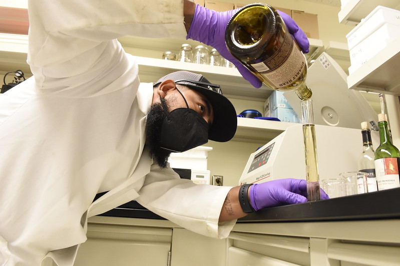 Esteban Garcia working with a beaker in VERC lab.