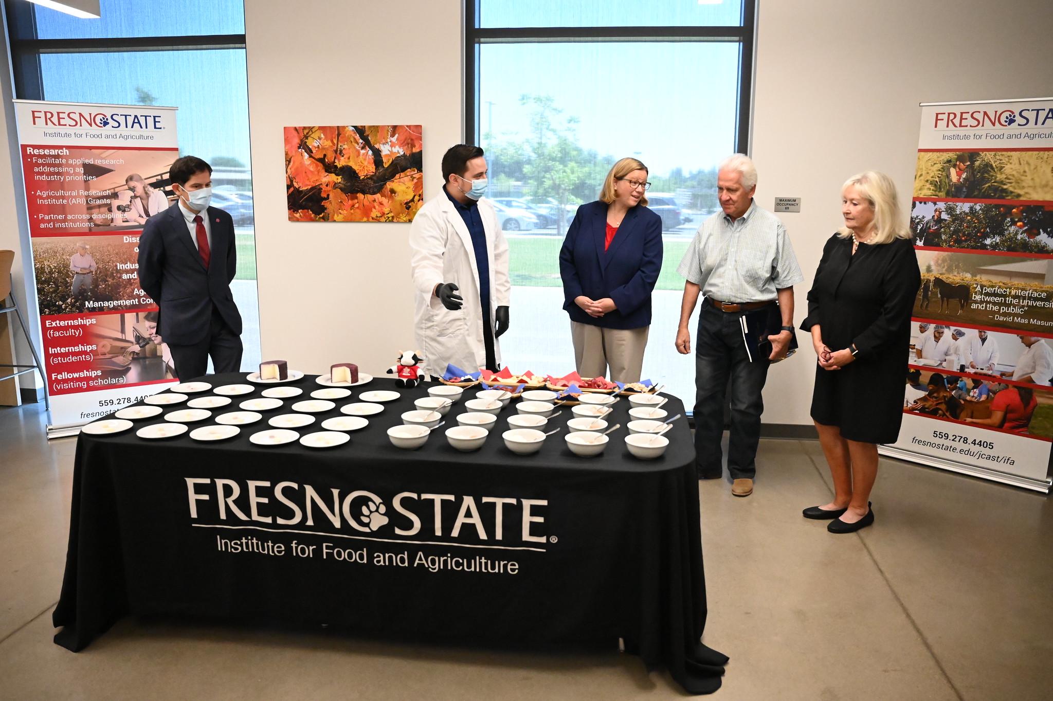 Fresno State President Saúl Jiménez-Sandoval and graduate student Daniel Olmos, USDA Under Secretary Jennifer Lester Moffitt, Congressional representatives Jim Costa and Connie Conway discuss his cheese research project.