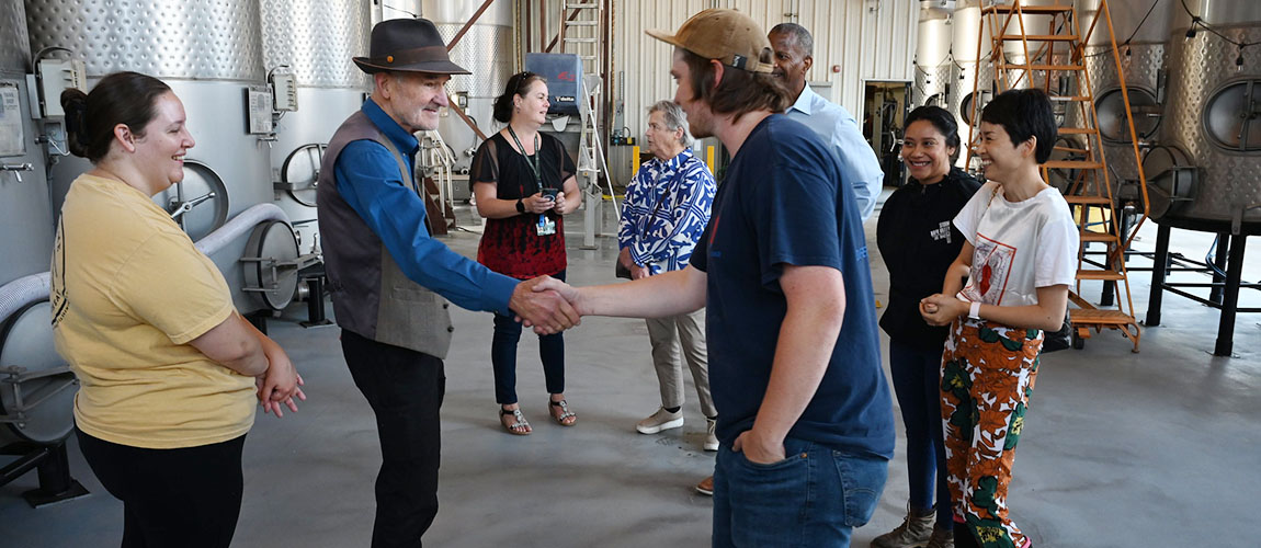 Alumnus David Hohnen meets Fresno State Winery student assistants.