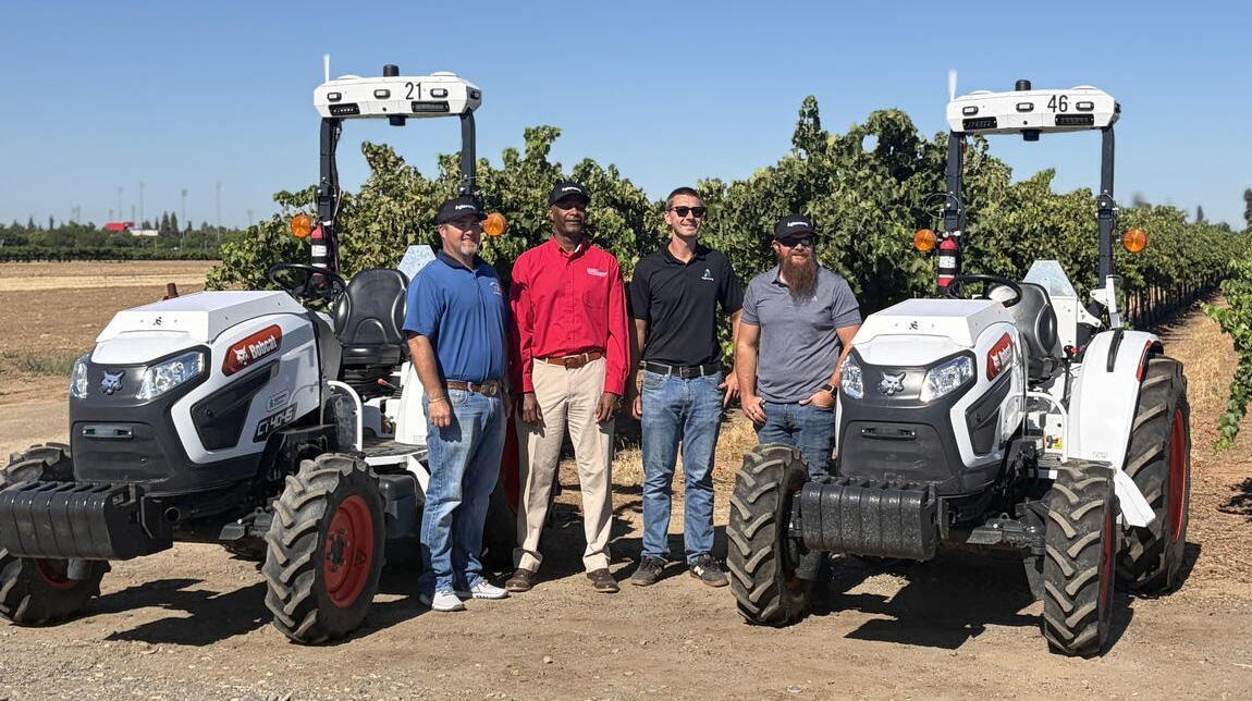Dean and mech ag faculty stand in front of Agtonomy tractors