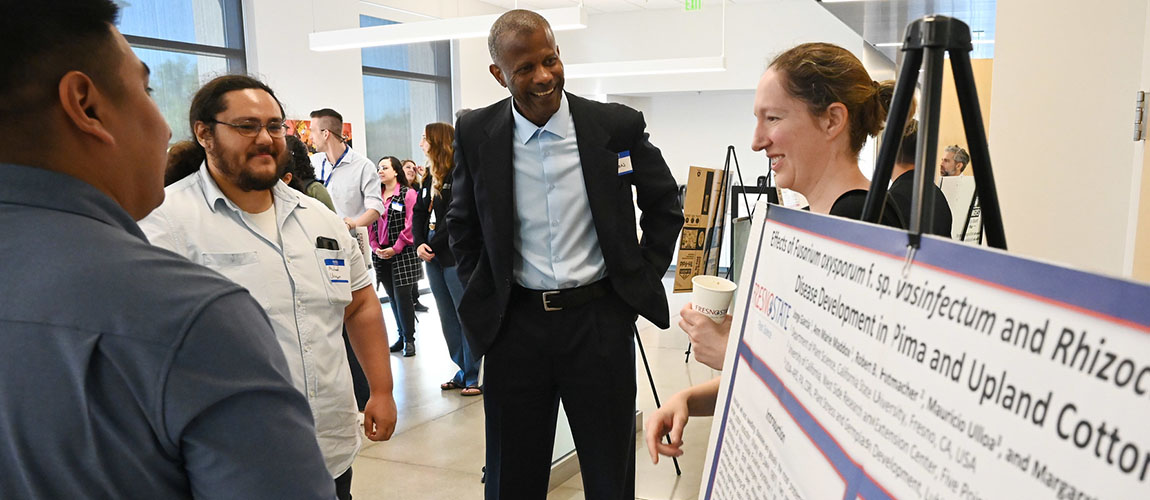 JCAST Dean Rolston St. Hilaire, plant science faculty Dr. Maraget Ellis and graduate student Michael Urner discuss their reserach.