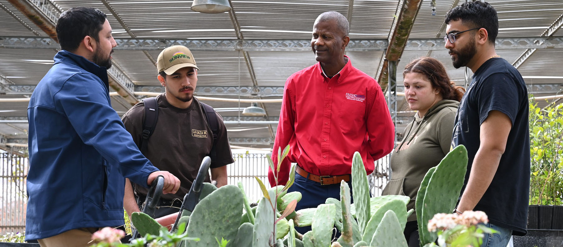 Fresno State Jordan College Dean Rolston St. Hilaire meets with campus nursery manager Ernesto Duran and student assistants Jacob Aguilar, Tonantzin Ortiz and Eric Shergill.