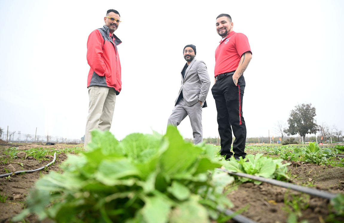 Agricultural Advancement Program faculty / staff Juan Rodriguez, Dr. Ranjit Riar and Juan Gonzales in campus vegetable plot