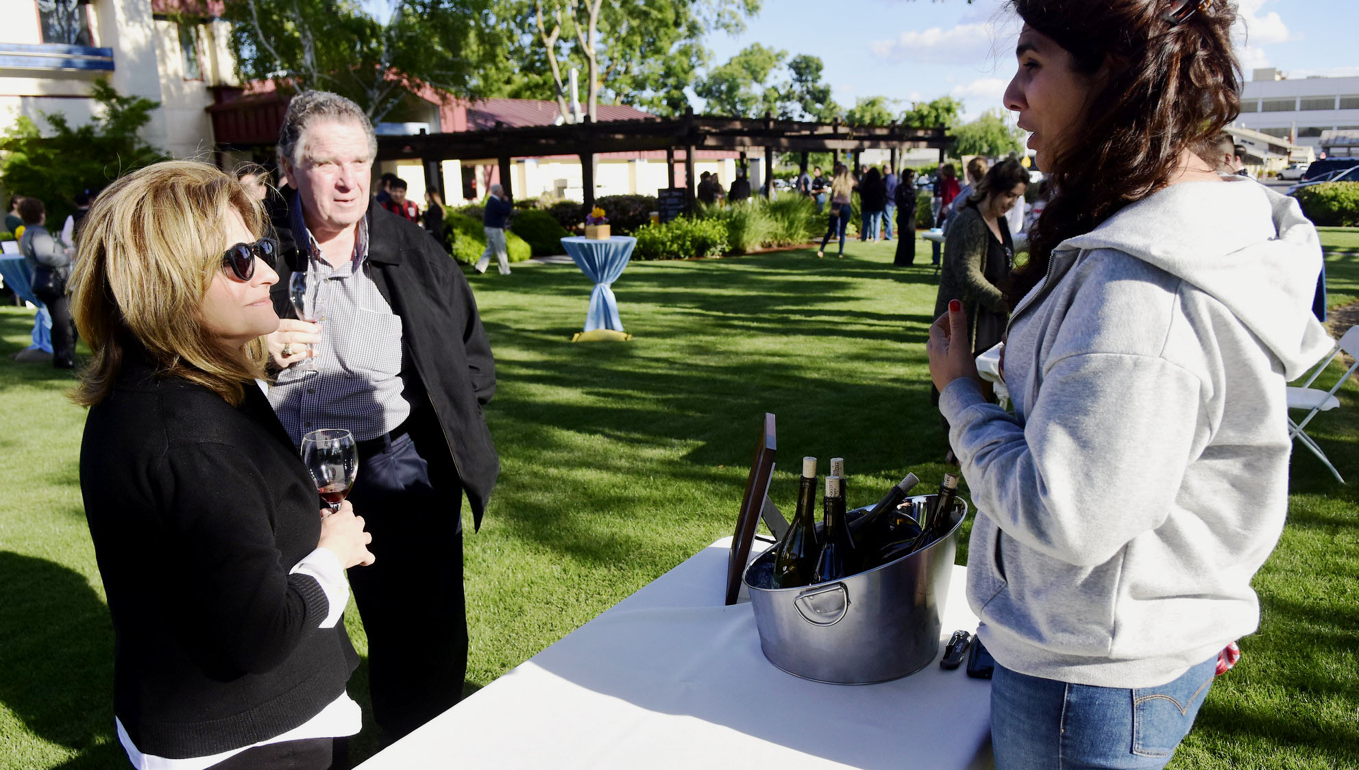 Nate DiBuduo, Dianne Nury, and student at the Taste of Spring event booth